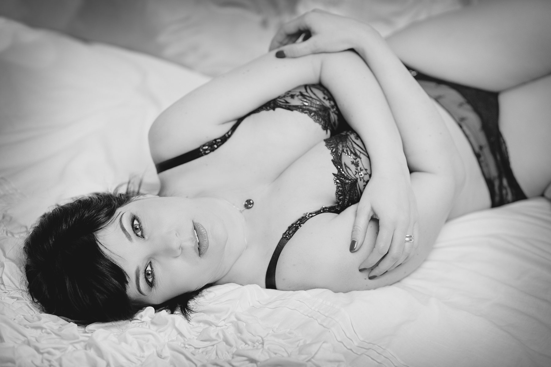 Černobílý boudoir detail ruky na prsou